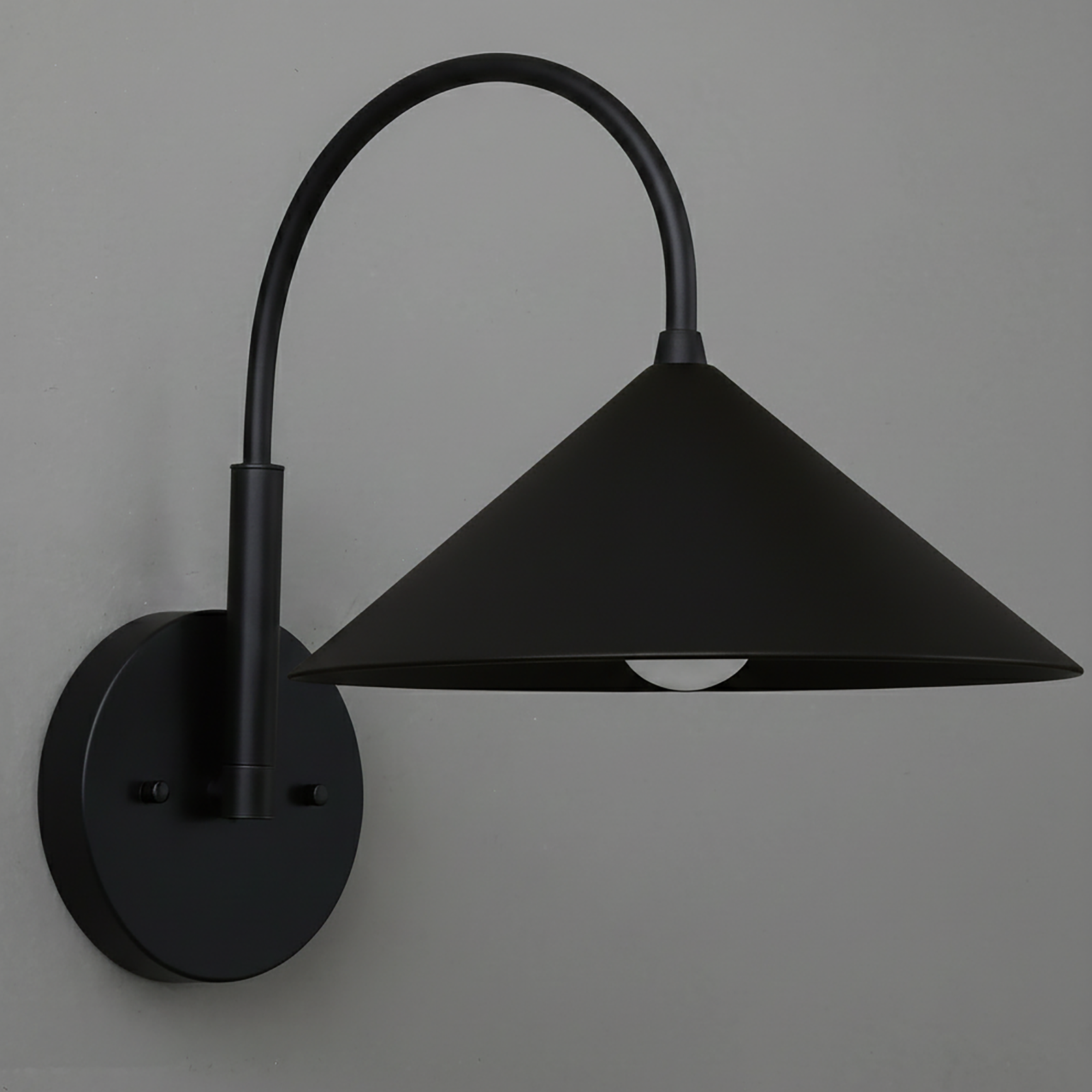 Black metal wall sconce with conical shade and curved arm mounted on round base. - Sconce Model No. 1583