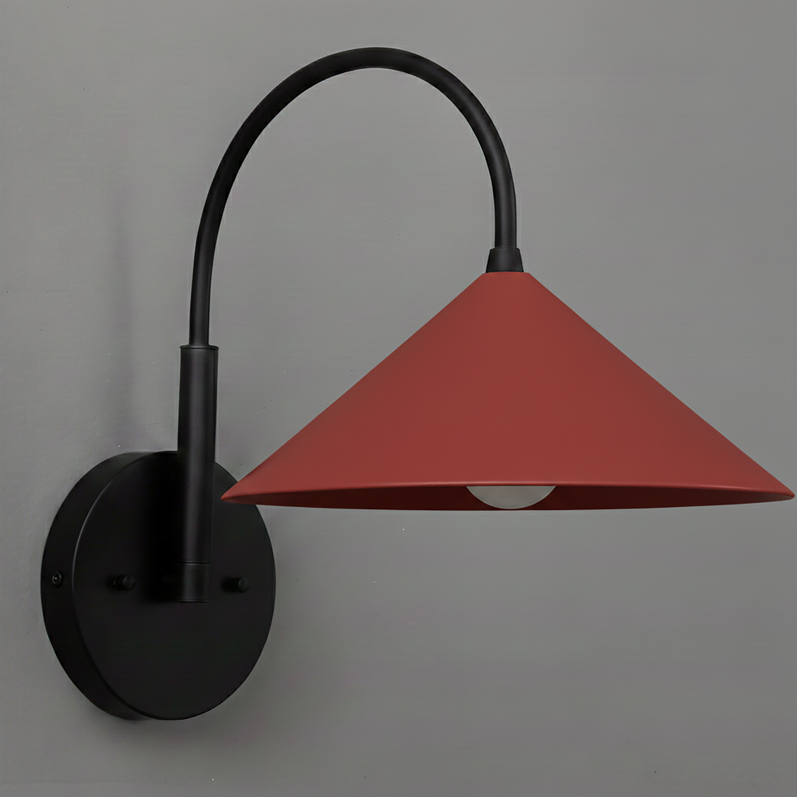 Black metal wall sconce with curved arm and matte brick red conical shade. - Sconce Model No. 1583