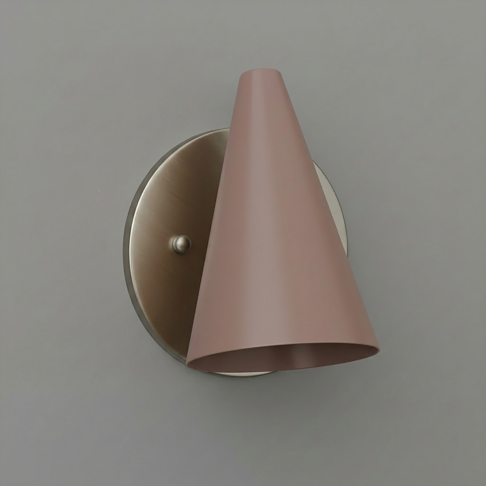 Matte pink metal cone-shaped wall sconce with brushed brass round backplate and single bulb fixture. - SCONCE MODEL NO. 5950
