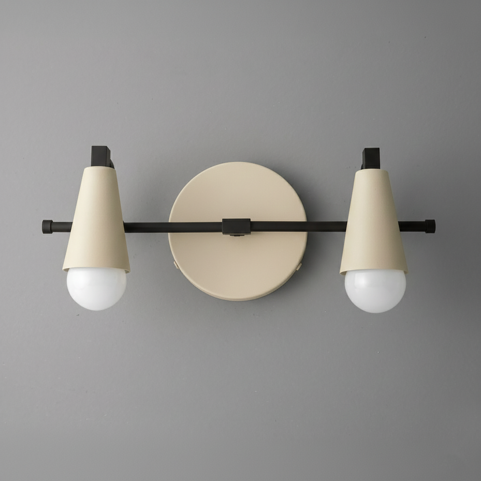 Two-light vanity fixture with black horizontal bar and beige conical shades over round beige wall mount. - VANITY LIGHT MODEL NO. 1229