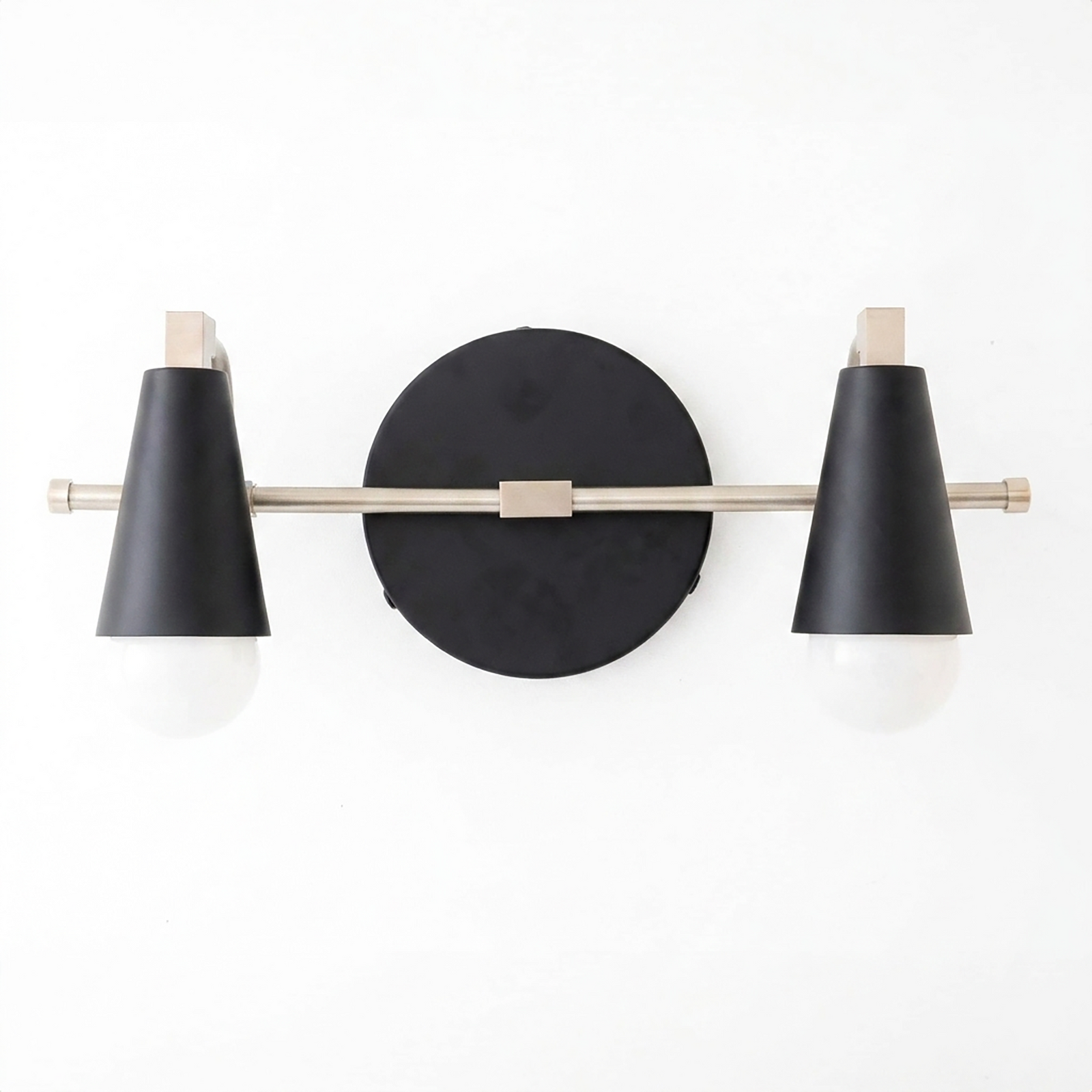 Scandinavian-style 2-bulb vanity light with black conical shades and brushed metal rod mounted on a round black base. - VANITY LIGHT MODEL NO. 1229