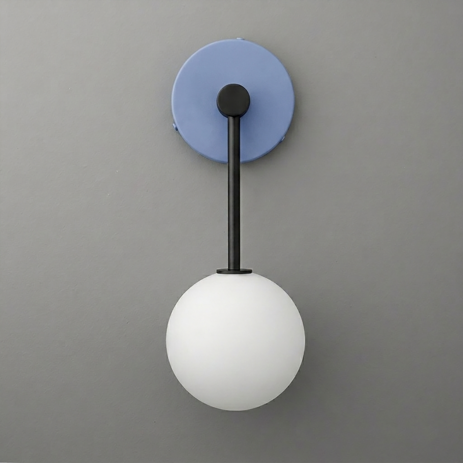 Black metal wall sconce with a round blue backplate and a white frosted glass globe shade. - Sconce Model No. 5999