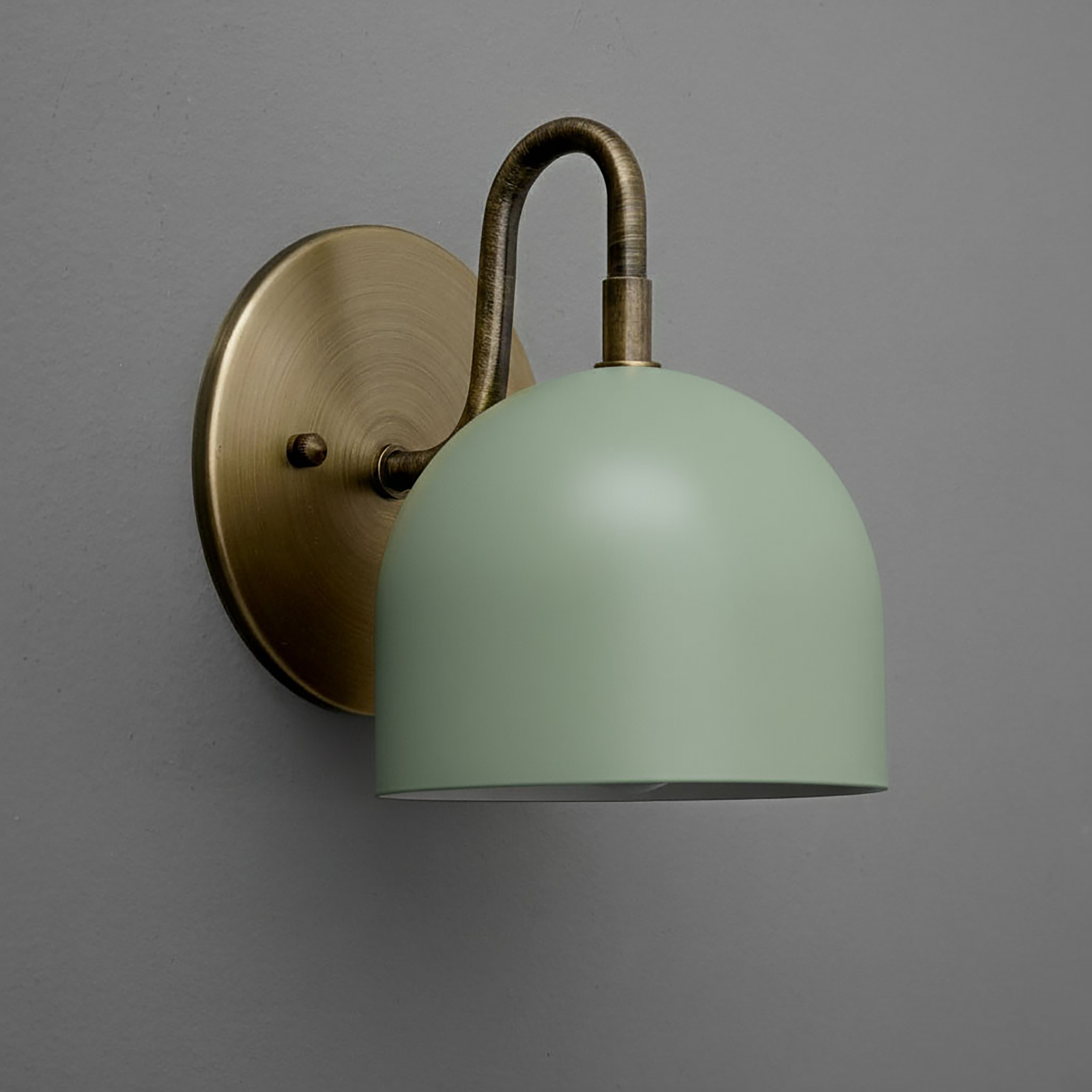 Matte sage green dome-shaped metal shade sconce with antique brass curved arm and round backplate. - Sconce Model No. 5416