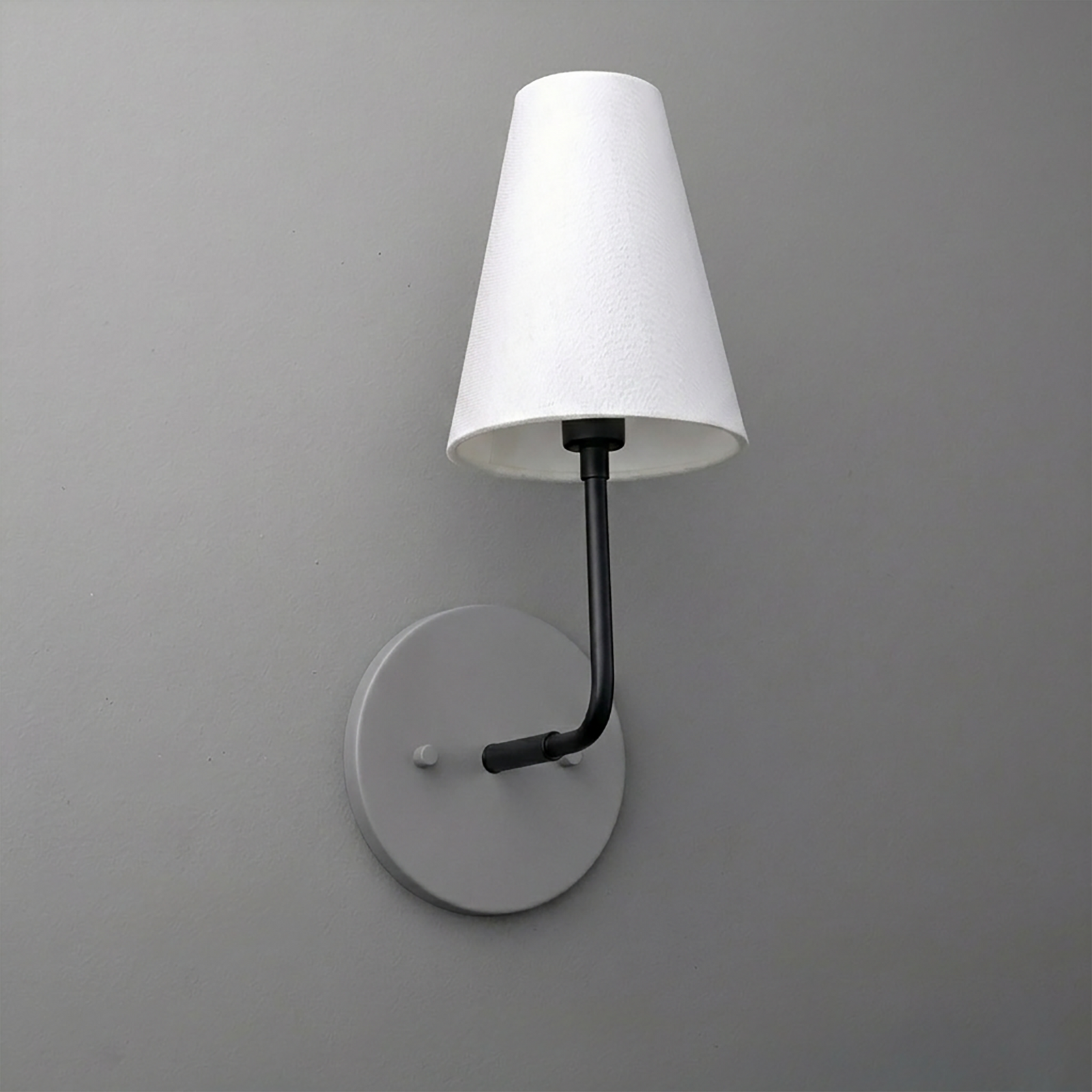Black metal wall sconce with round base and white tapered fabric shade. - SCONCE MODEL NO. 3928