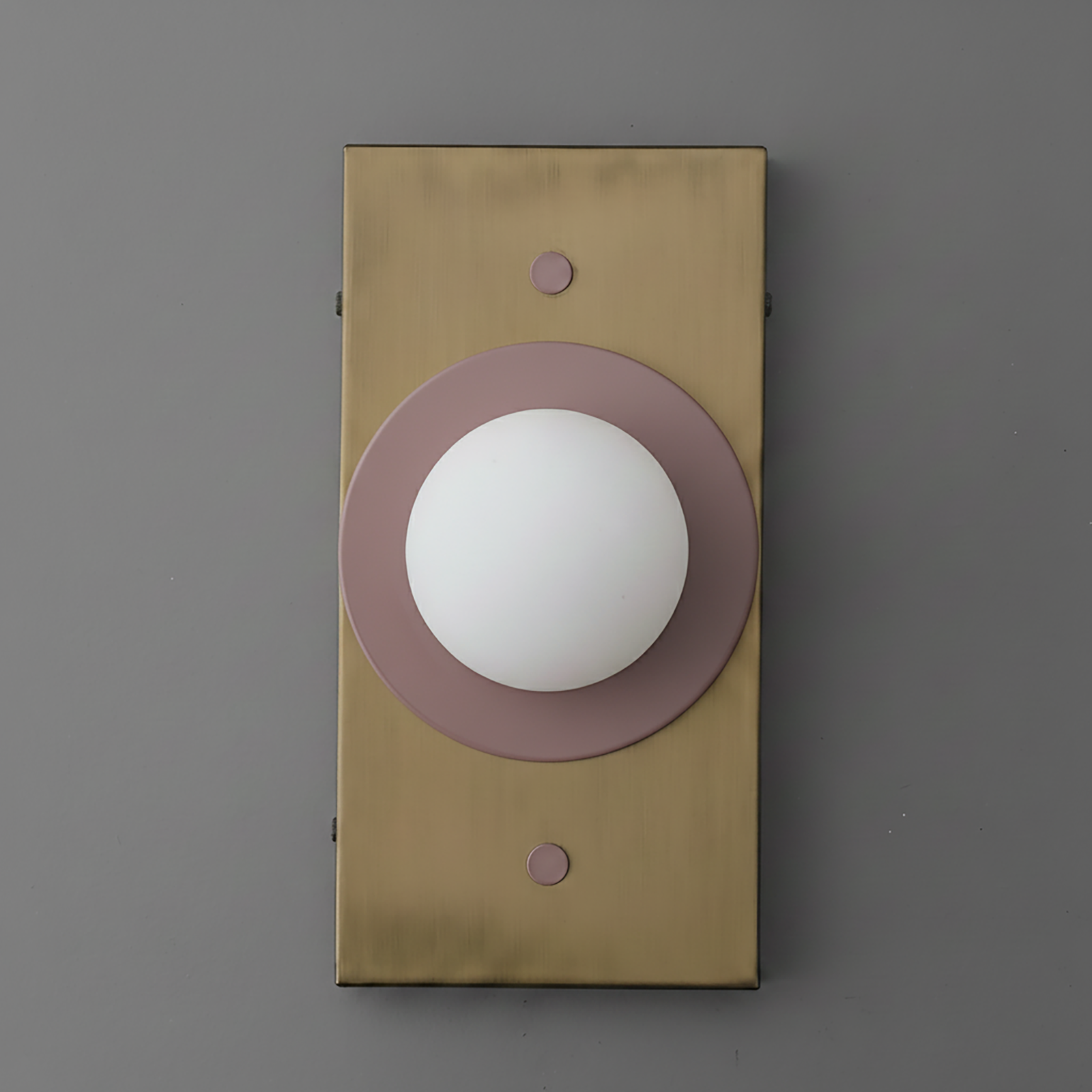 Minimalist wall sconce with antique brass rectangular backplate and mauve circular accent around white globe light. - SCONCE MODEL NO. 4474