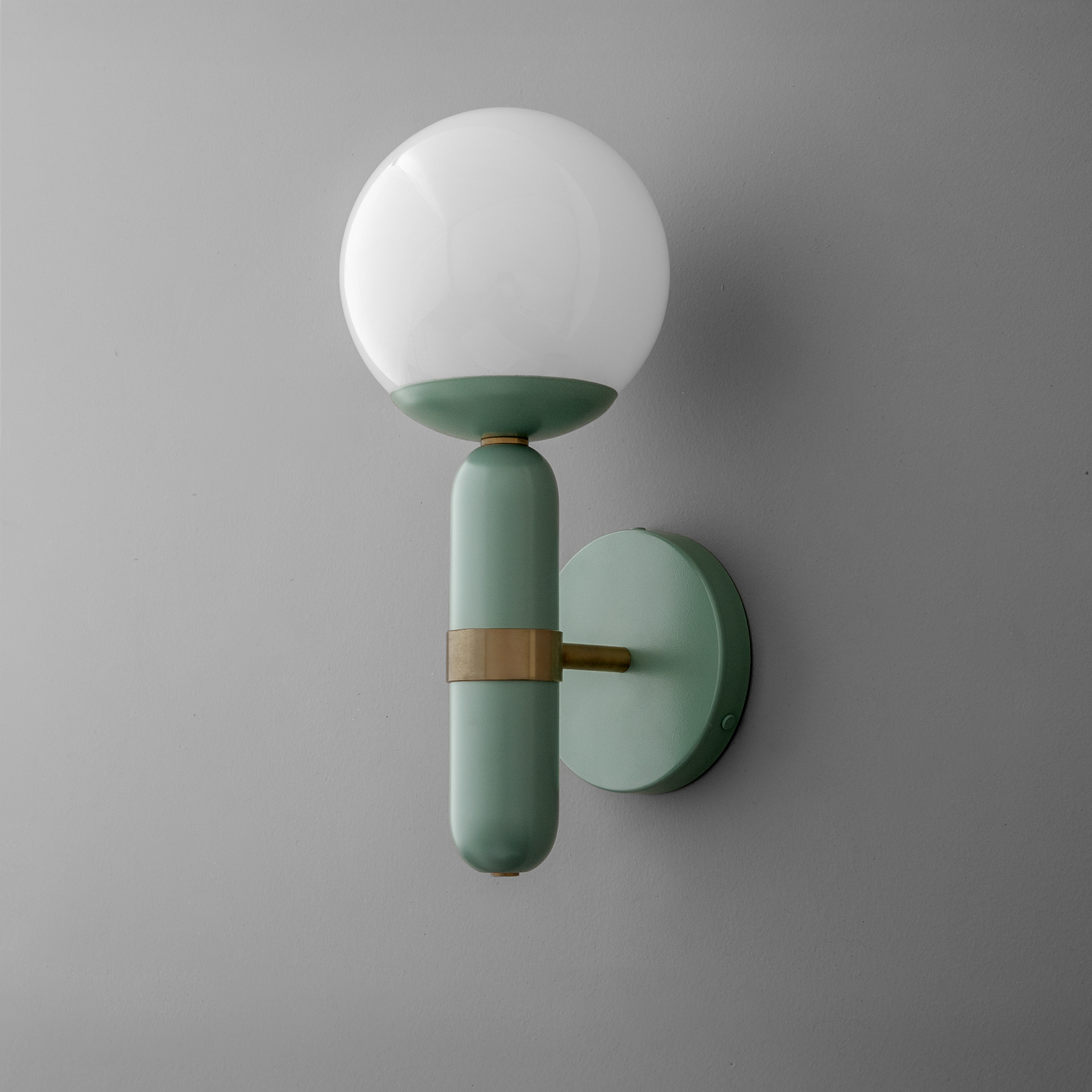 Wall sconce with matte green cylindrical base, brass accent, and frosted white globe shade. - SCONCE MODEL NO. 4786