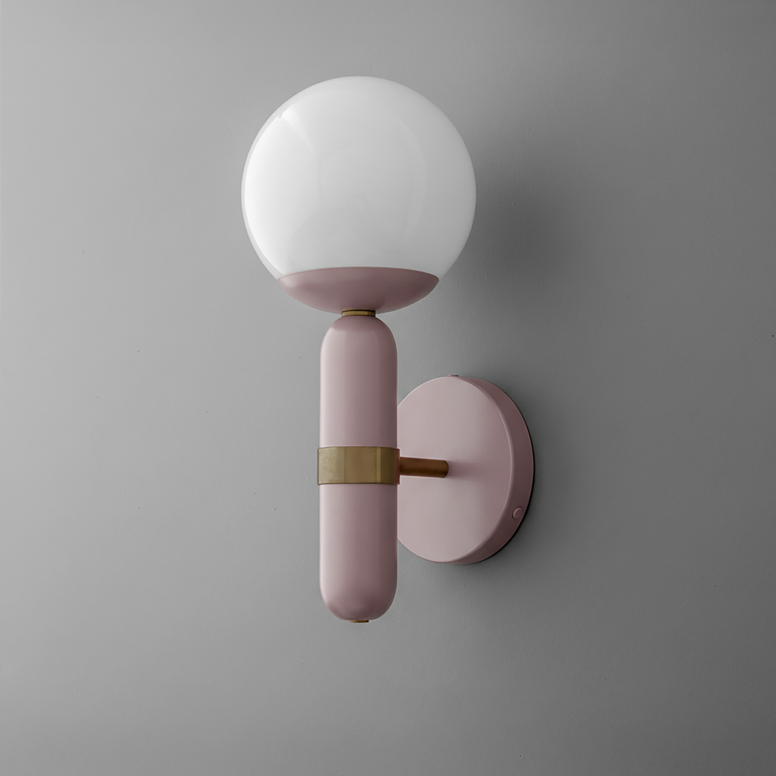 Wall sconce with round white glass globe and mauve cylindrical base with brass accent on gray background. - SCONCE MODEL NO. 4786