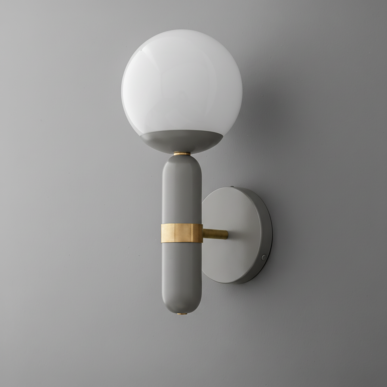 Gray and raw brass wall sconce with frosted white glass globe shade on round metal backplate. - SCONCE MODEL NO. 4786