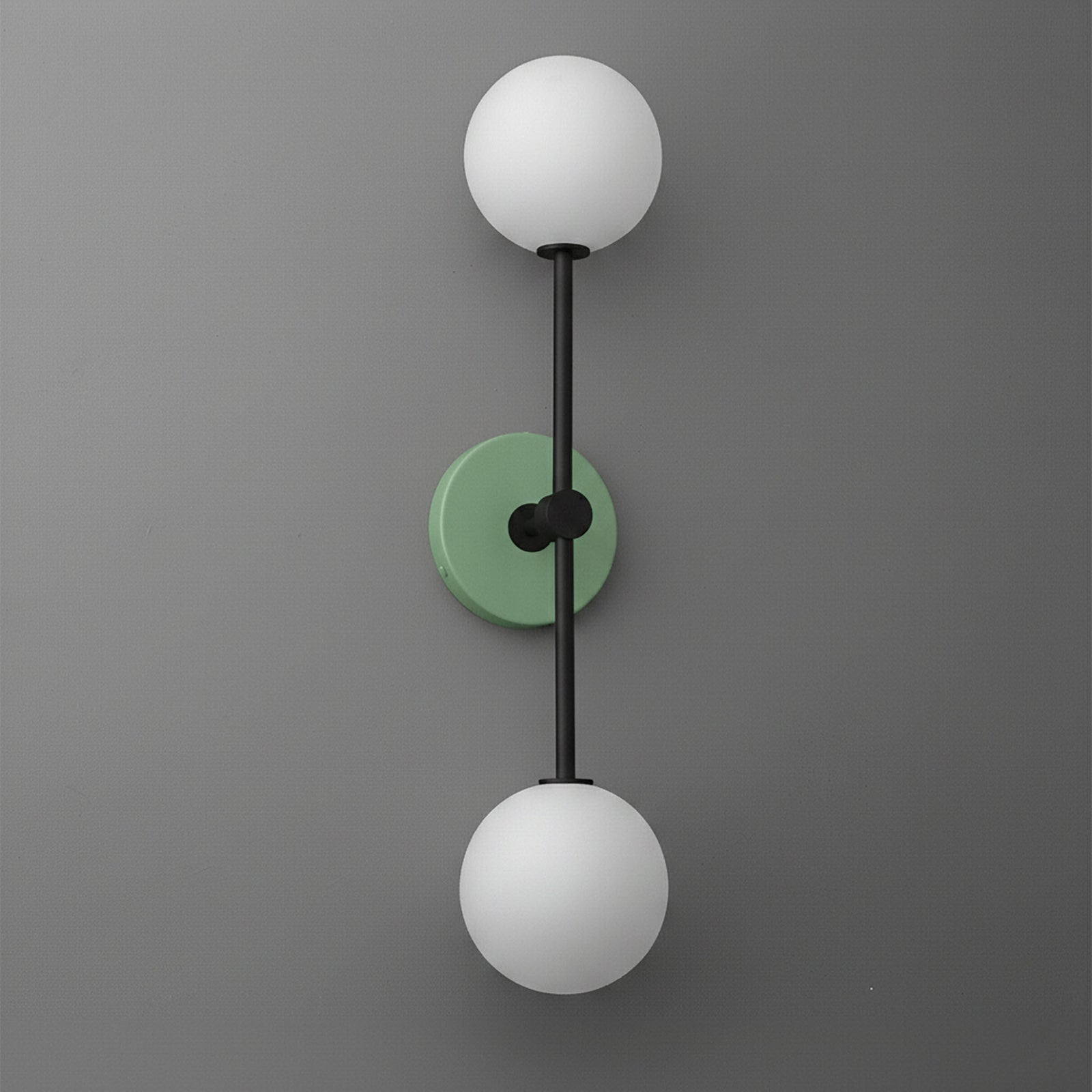 Wall sconce with black metal frame, green round backplate, and two white globe glass shades. - SCONCE MODEL NO. 9776