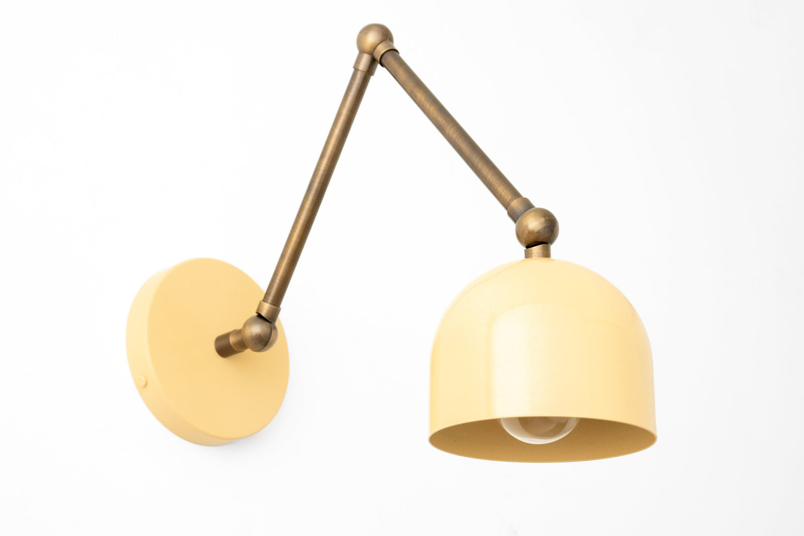 Adjustable industrial-style wall sconce with brass finish arm and matte yellow dome shade. - SCONCE MODEL NO. 5998