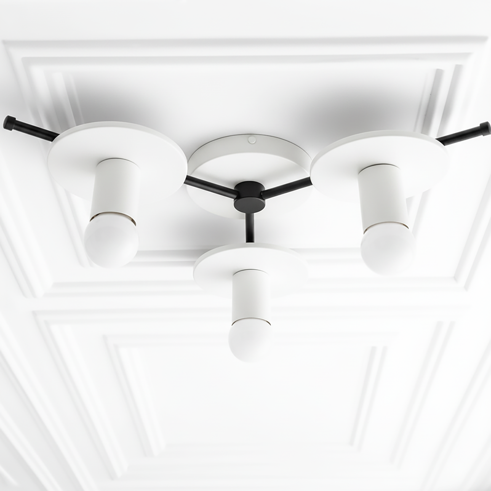 Mid-century modern chandelier flush mount with three white cylindrical shades and black metal arms on decorative white. - CHANDELIER MODEL NO. 9526