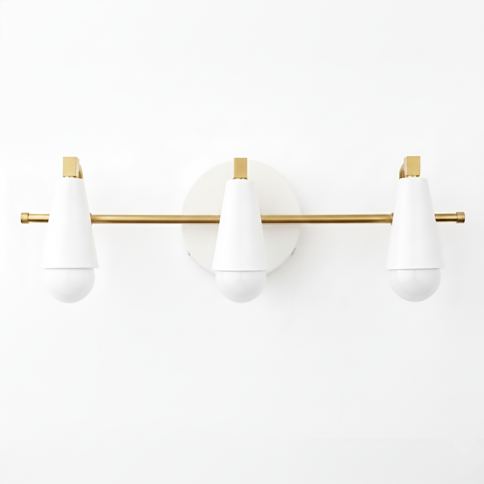 Three-light vanity fixture with white cone-shaped shades and a horizontal gold rod mounted on a round white base. - VANITY LIGHT MODEL NO. 8084