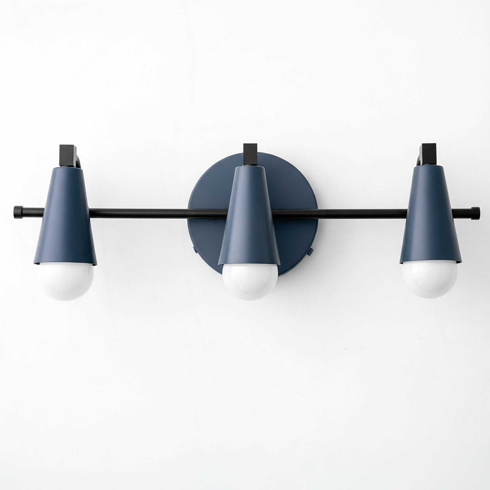 Three-bulb vanity light with matte blue cone-shaped shades and black metal horizontal rod mounting on round wall plate. - VANITY LIGHT MODEL NO. 8084