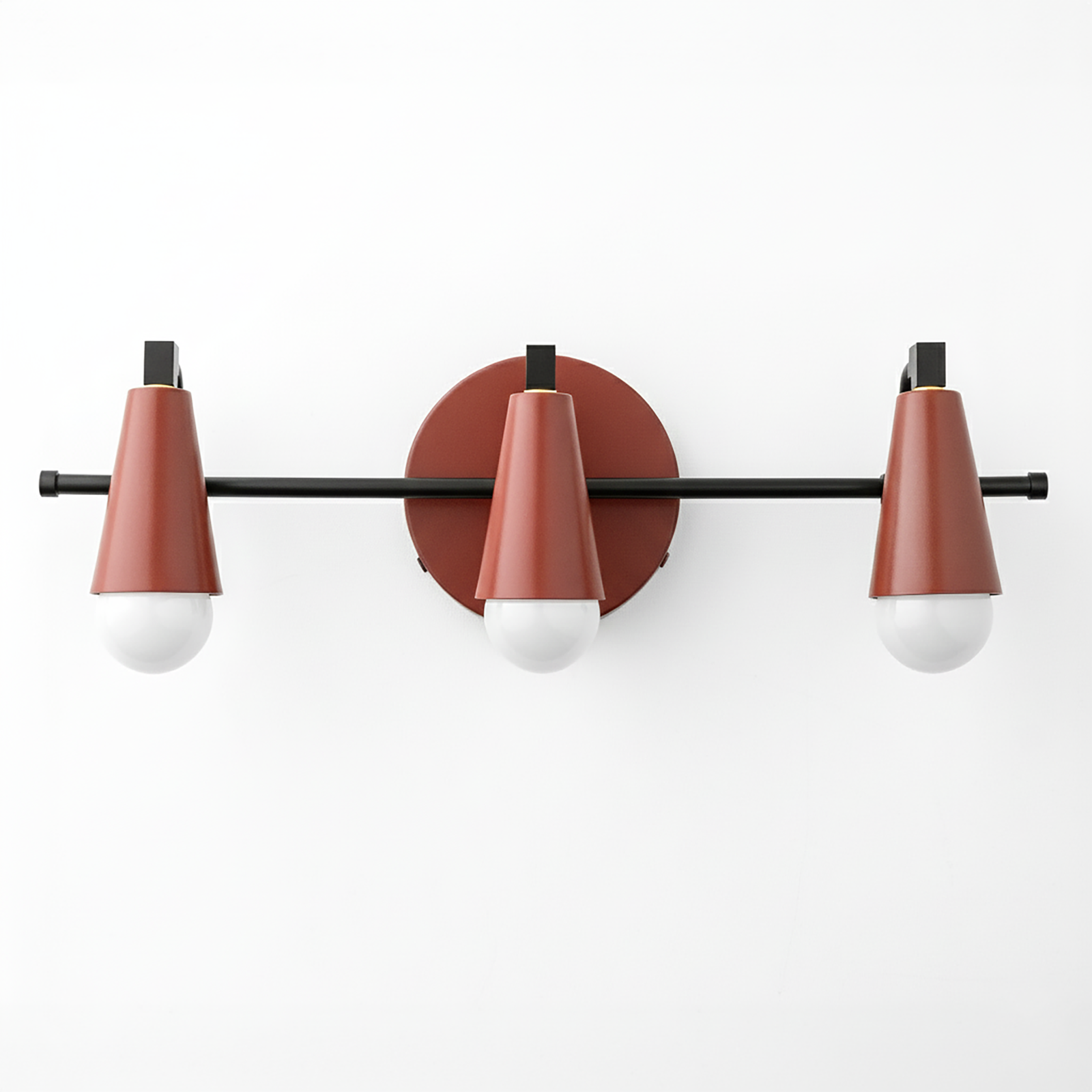 Three-light vanity fixture with matte black horizontal rod and rust-red conical metal shades over white round bulbs. - VANITY LIGHT MODEL NO. 8084