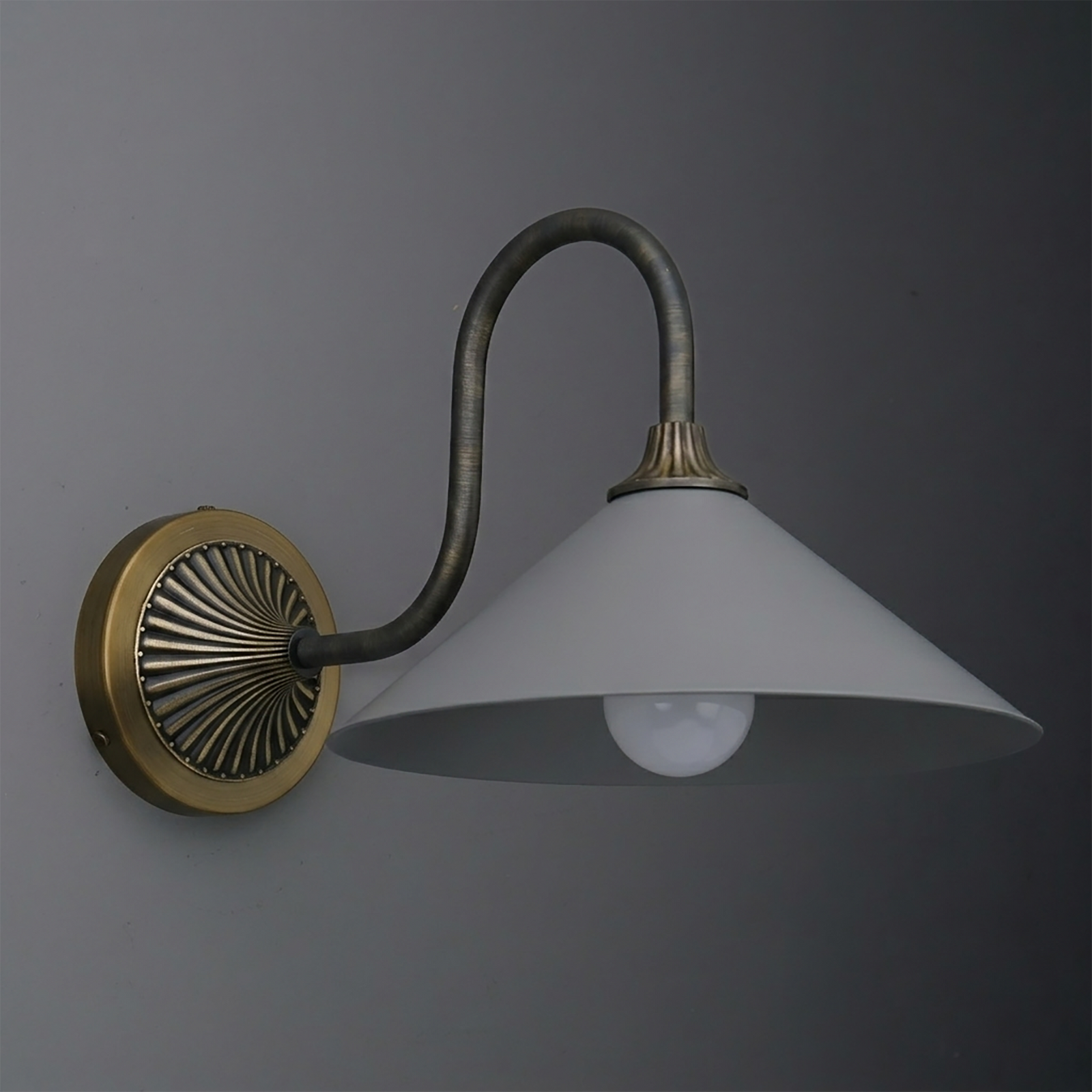 Wall sconce with aged brass circular base, curved dark metal arm, and wide white conical shade. - SCONCE MODEL NO. 1031