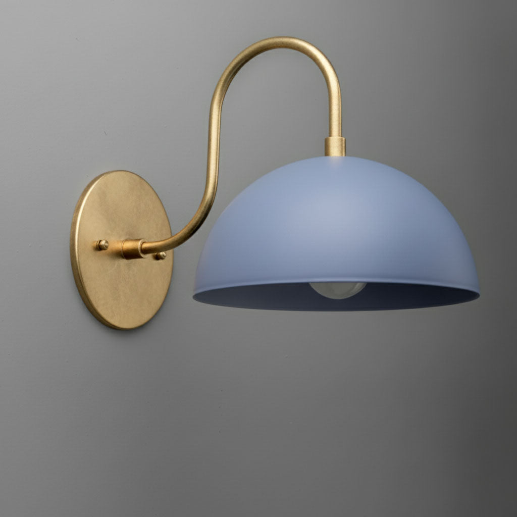 Antique brass wall sconce with curved arm and periwinkle dome shade against gray wall. - SCONCE MODEL NO. 9092