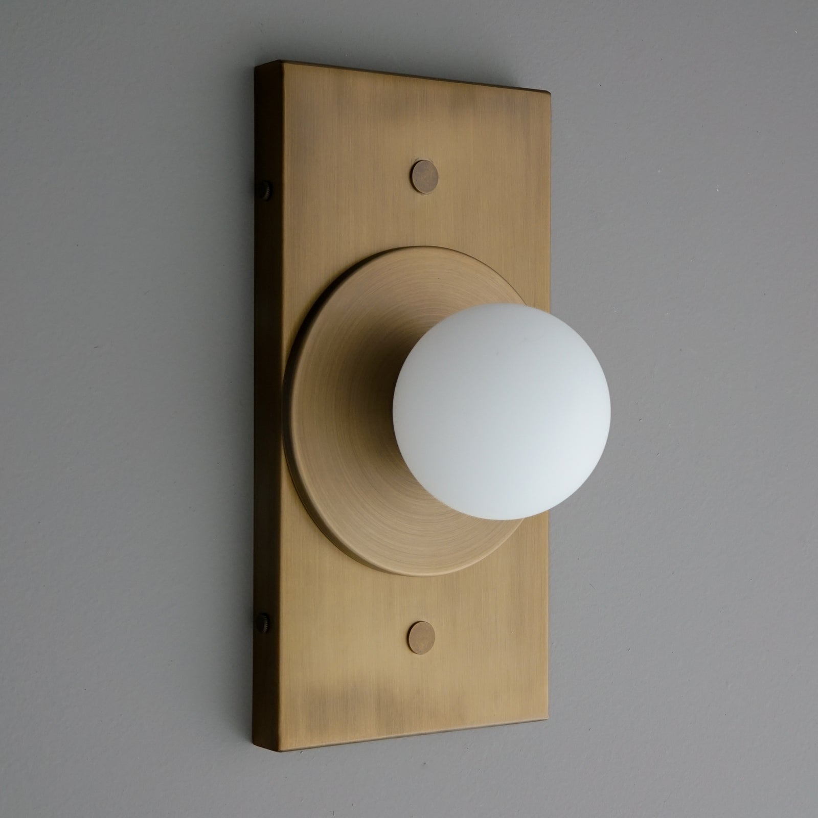 Antique brass rectangular wall sconce with round frosted glass globe light. - SCONCE MODEL NO. 4474