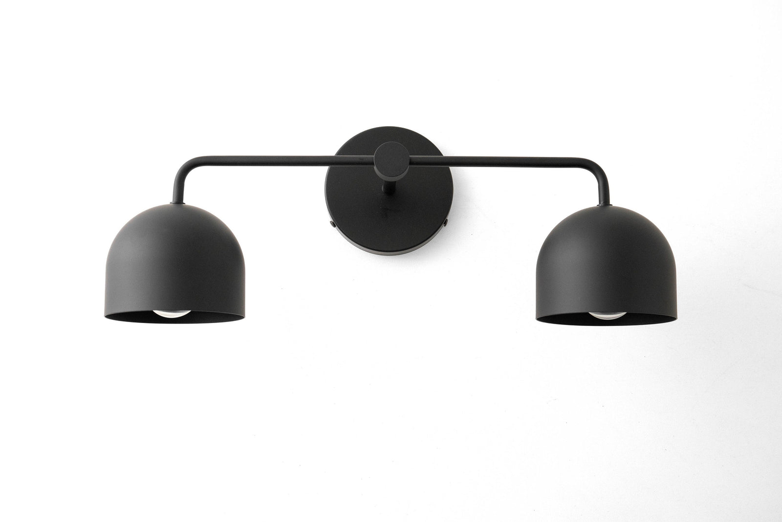 Mid-century modern black metal vanity light with two dome-shaped shades and round wall mount. - VANITY LIGHT MODEL NO. 2082