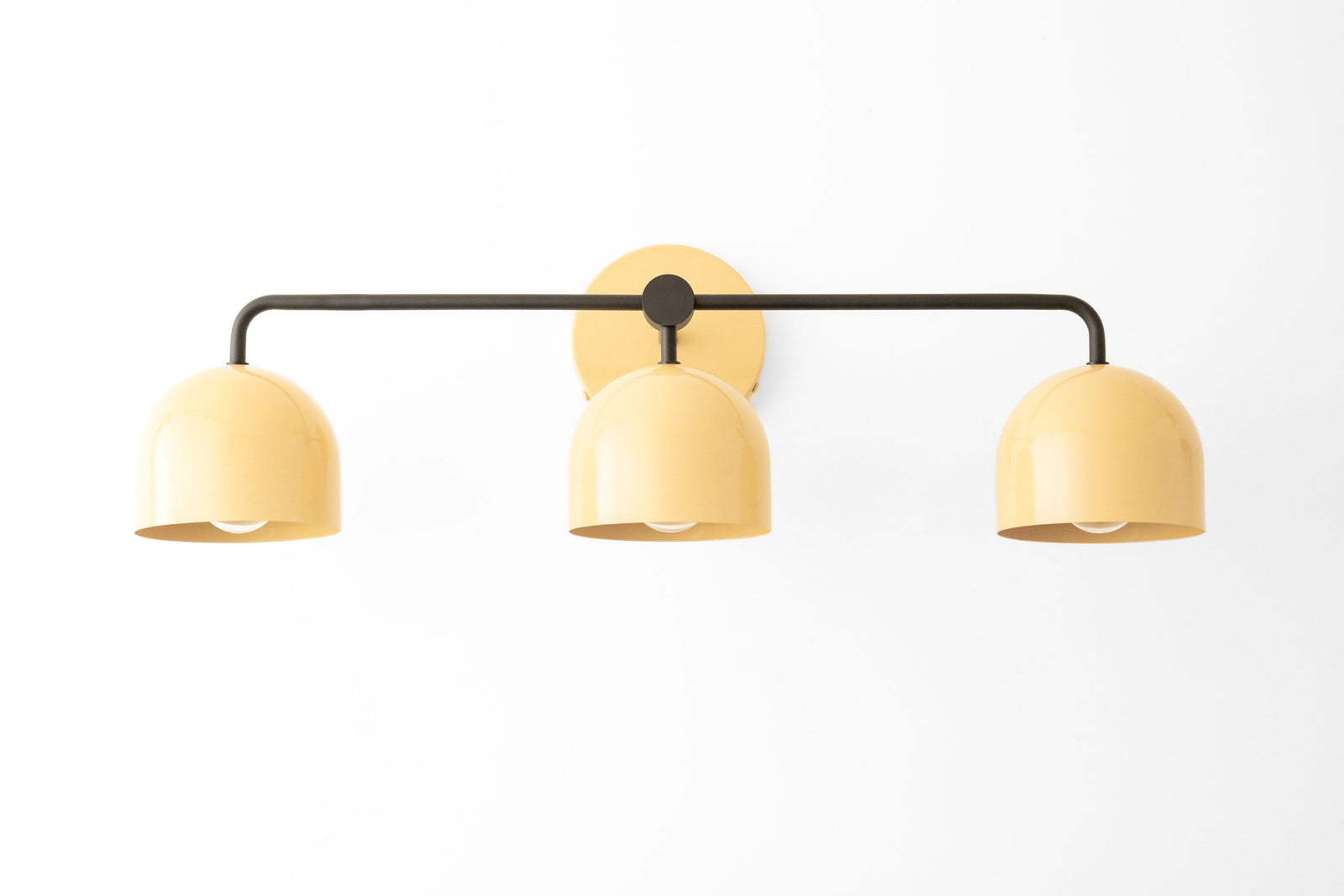 Mid-century modern vanity light with three pale yellow metal shades and black horizontal bar. - VANITY LIGHT MODEL NO. 7456