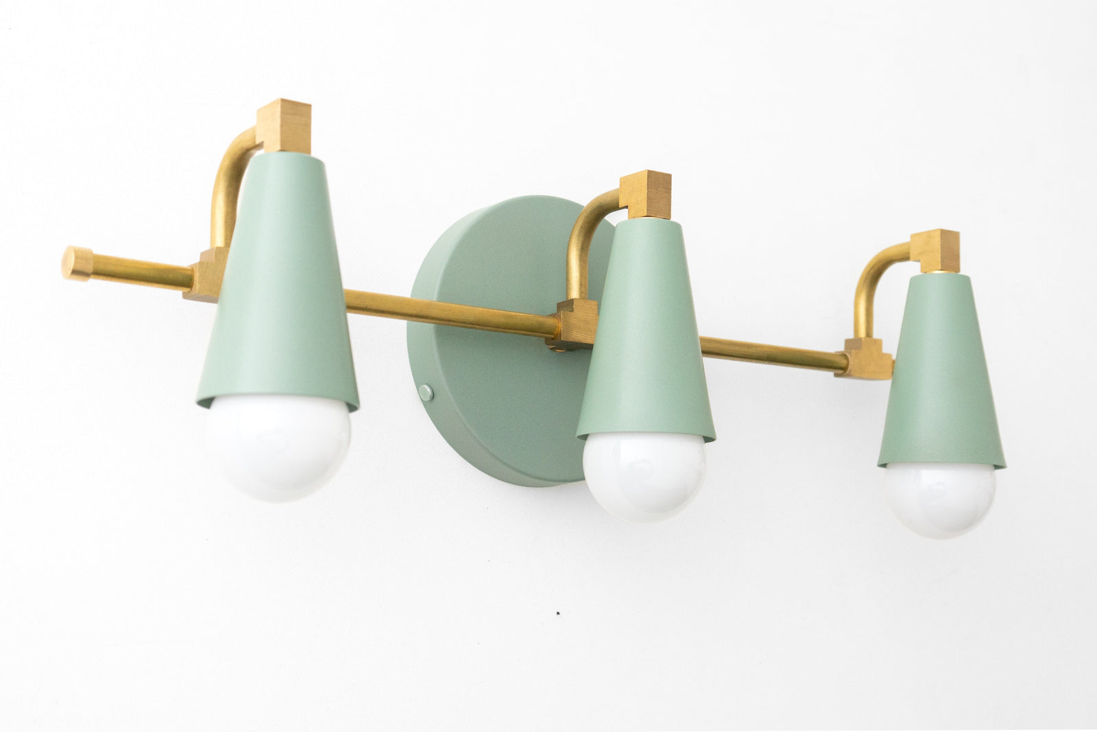 Mid-century modern 3-bulb vanity light with matte sage green shades and brushed brass fixture. - VANITY LIGHT MODEL NO. 8084