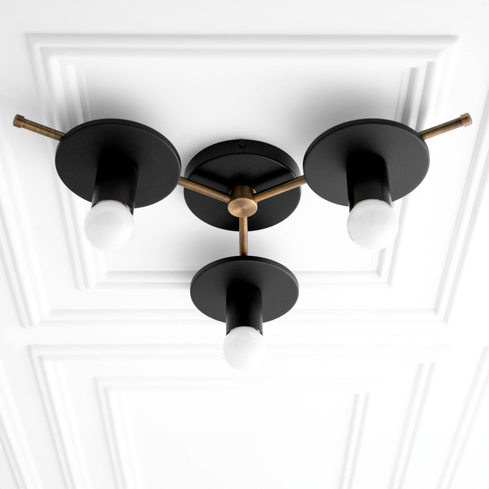 Mid-century modern flush mount chandelier with three black metal shades and antique brass accents. - CHANDELIER MODEL NO. 9526
