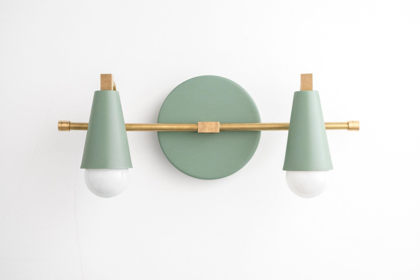 Two-bulb vanity light with matte green cone shades and raw brass horizontal bar on round green base. - VANITY LIGHT MODEL NO. 1229