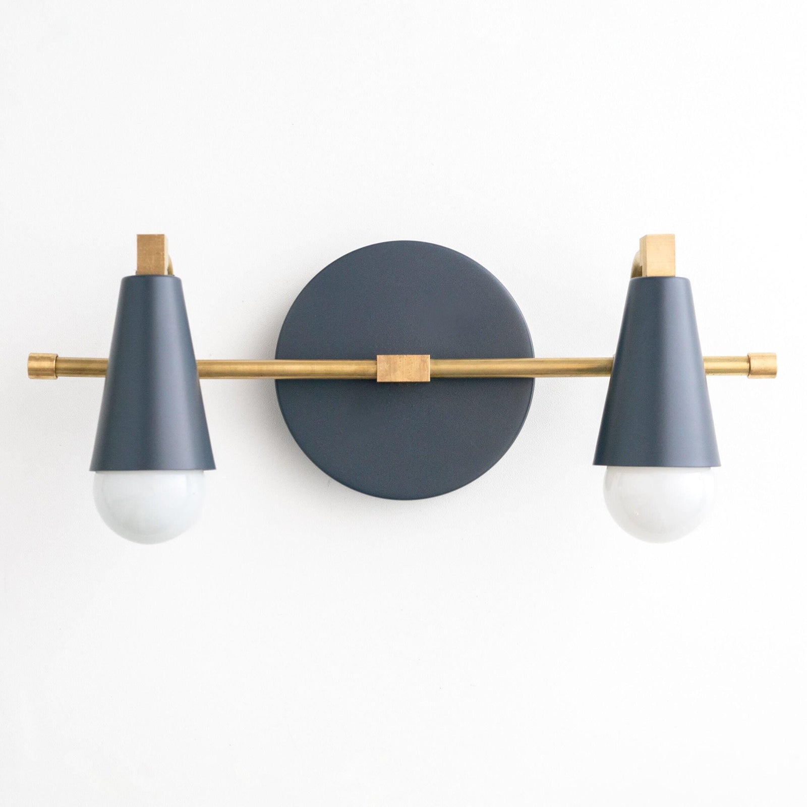 Two-bulb vanity light with raw brass rod and coal blue cone shades on round backplate. - VANITY LIGHT MODEL NO. 1229