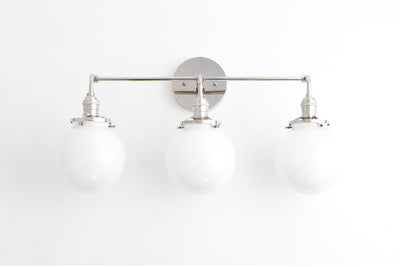 VANITY MODEL No. 8705- Mid Century Modern bathroom lighting with a Opal Globe finish. Designed and produced by MODCREATIONStudio at Peared Creation
