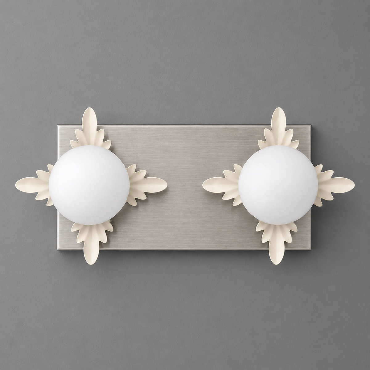 Brushed nickel rectangular wall sconce with two round white glass bulbs and decorative leaf accents. - SCONCE MODEL NO. 1114