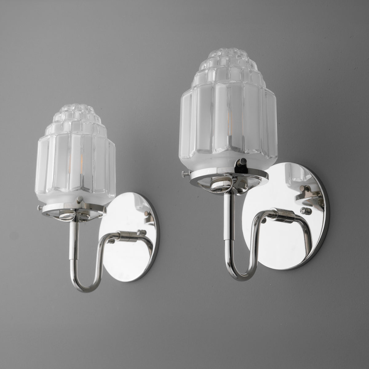Pair of chrome wall sconces with embossed frosted glass shades and round backplates. - SCONCE MODEL NO. 1035