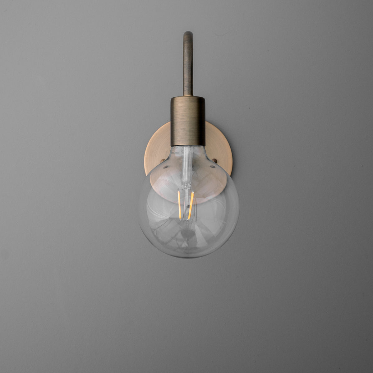 Minimalist wall sconce with exposed clear glass bulb and brushed metal finish. - SCONCE MODEL NO. 4753