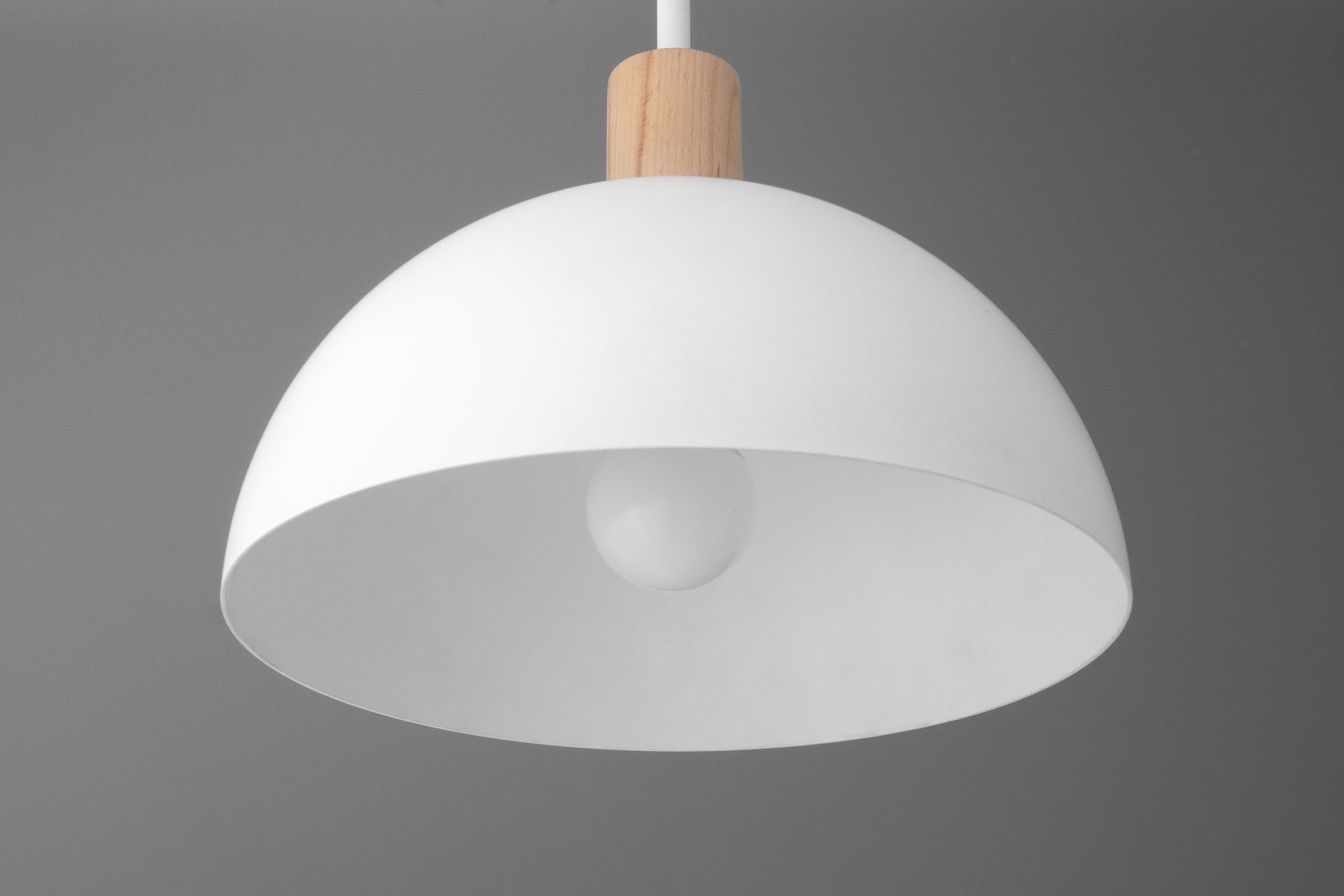White dome-shaped pendant light with wooden accent and visible light bulb. - PENDANT MODEL NO. 4610