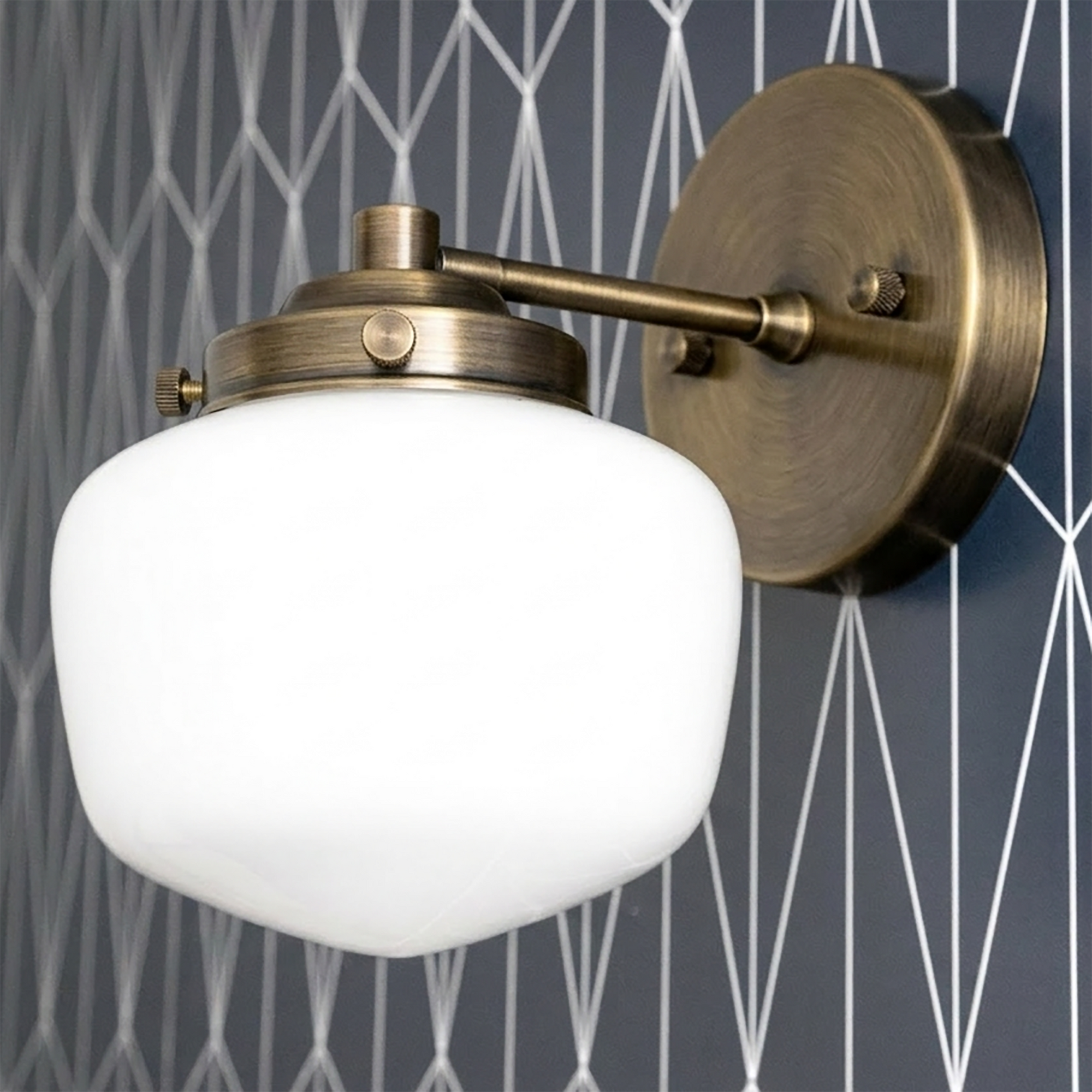 Art Deco wall sconce with round white glass globe and brushed antique brass fixture. - SCONCE MODEL NO. 7322