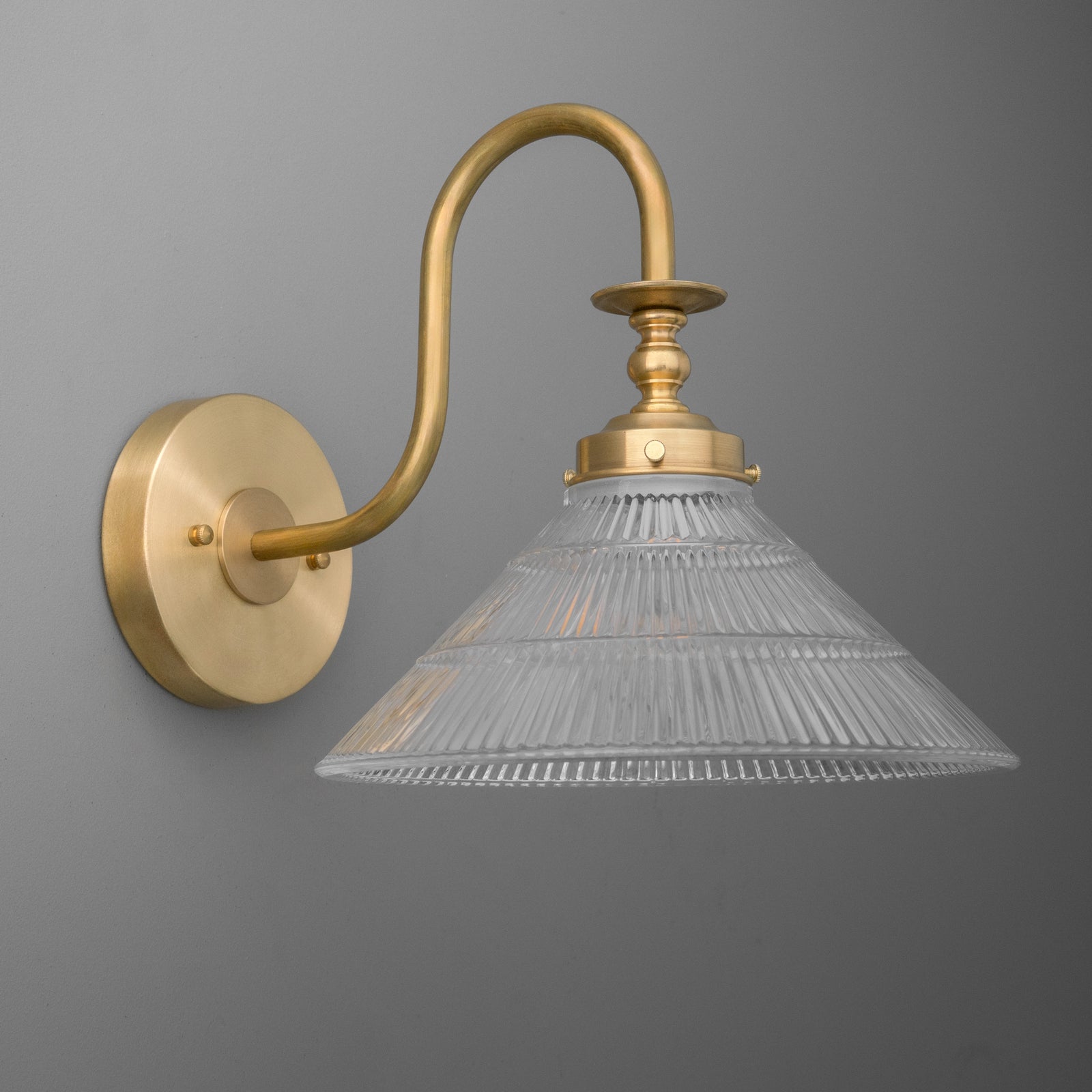 Wall sconce with curved brass arm and ribbed clear glass conical shade. - SCONCE MODEL NO. 8036