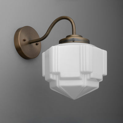 Antique brass wall sconce with geometric frosted glass shade and curved arm. - SCONCE MODEL NO. 1058