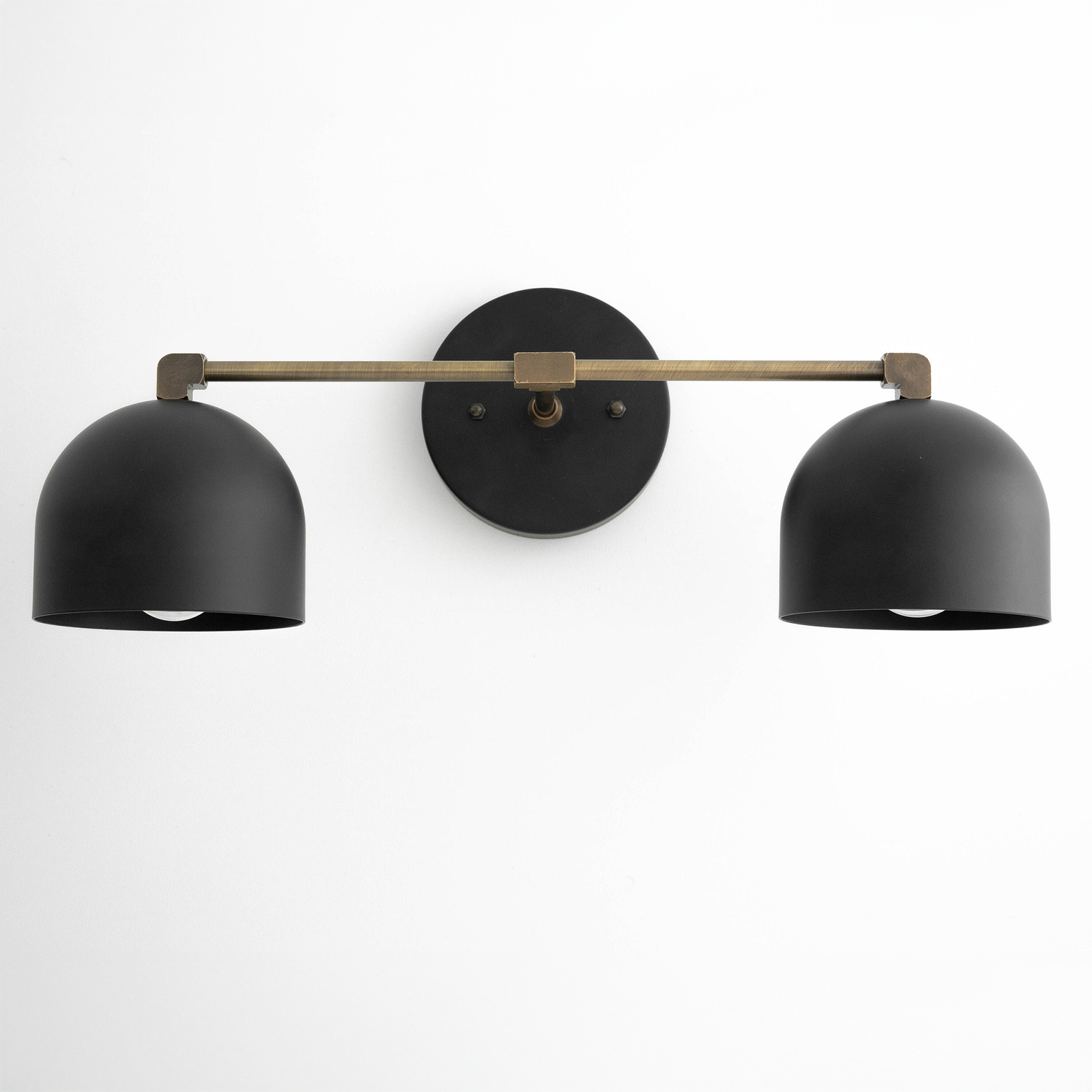 Mid century modern two-bulb vanity light with black dome shades and antique brass horizontal bar. - VANITY LIGHT MODEL NO. 0698