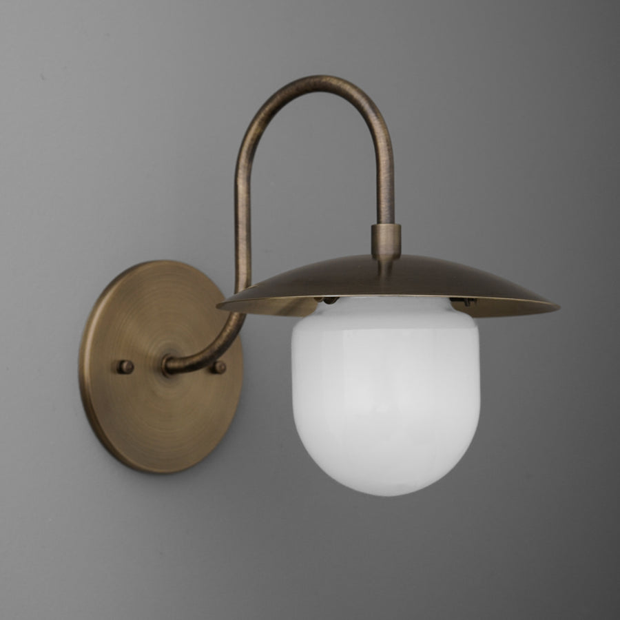 Antique brass wall sconce with curved arm and white frosted glass globe shade. - SCONCE MODEL NO. 7191