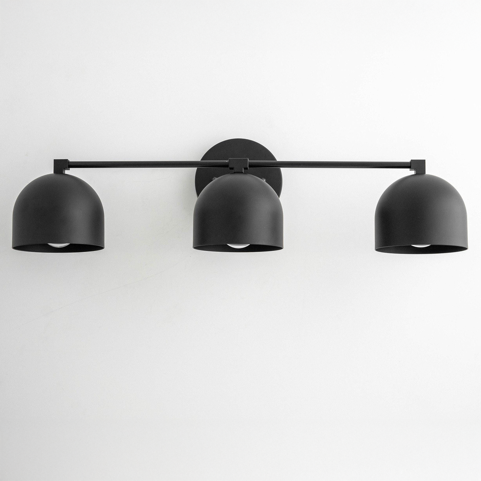 Mid-century modern black vanity light with three dome-shaped shades and horizontal bar mount. - VANITY LIGHT MODEL NO. 7565