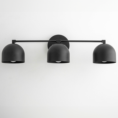 Black mid-century modern three-light vanity fixture with dome-shaped metal shades and horizontal bar mount. - VANITY LIGHT MODEL NO. 7565