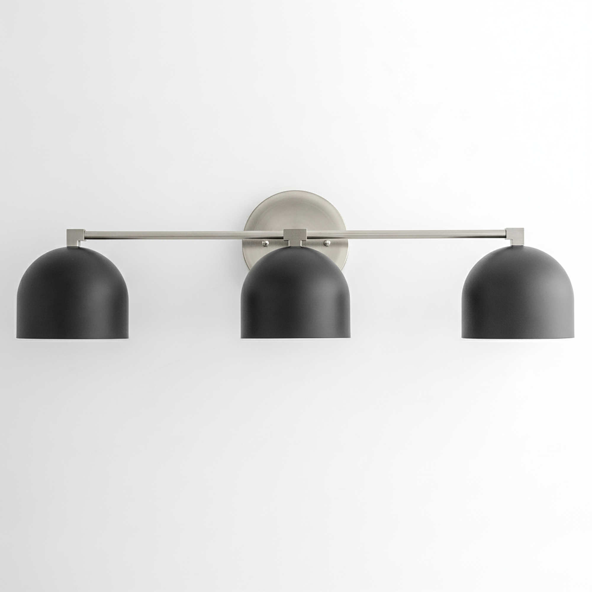 Mid-century modern 3-bulb vanity light with brushed nickel bar and matte black dome shades. - VANITY LIGHT MODEL NO. 7565