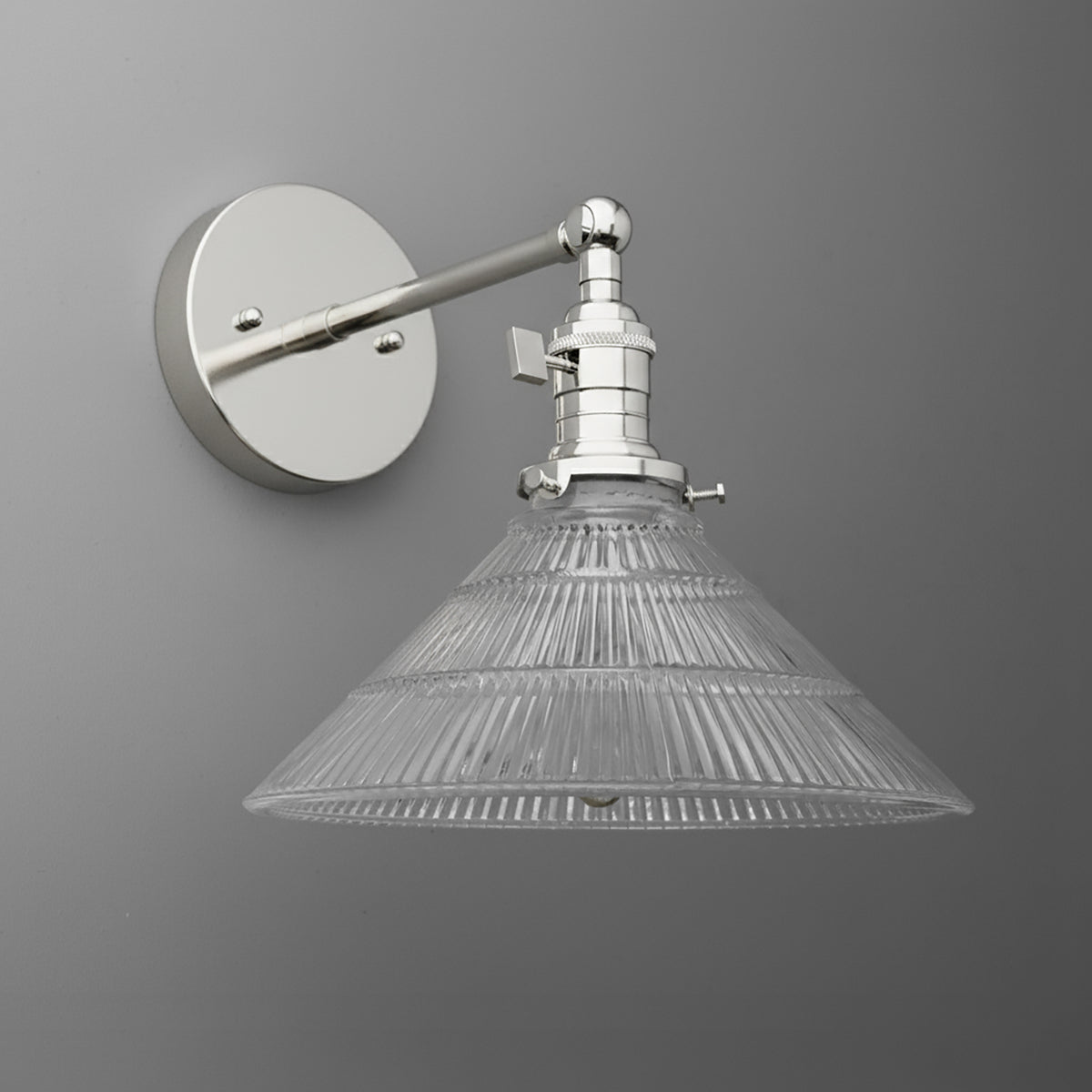 Wall-mounted sconce with clear ribbed glass shade and polished metal arm and base. - SCONCE MODEL NO. 3170