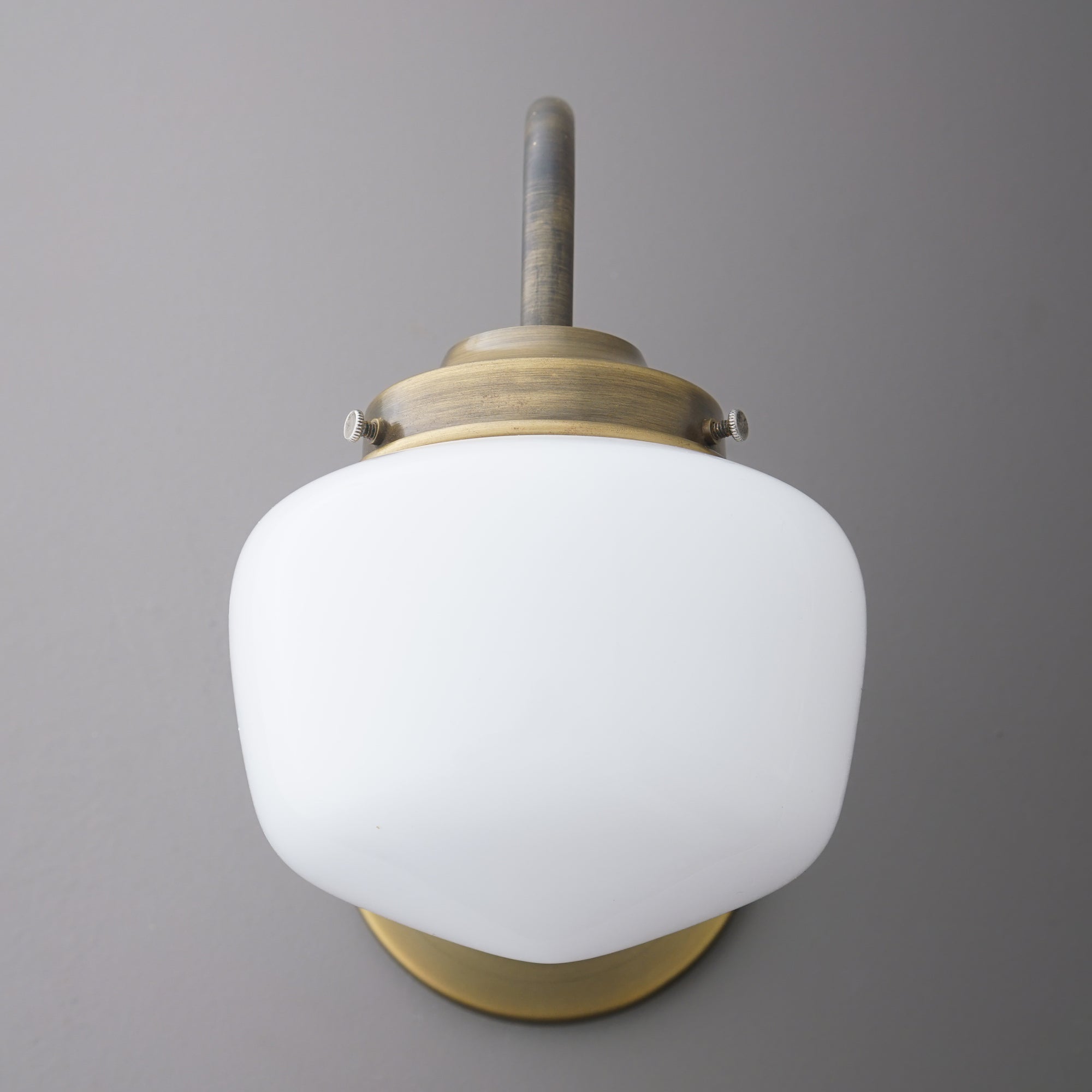 Wall sconce with frosted white glass shade and brushed brass metal fixture. - SCONCE MODEL NO. 1012