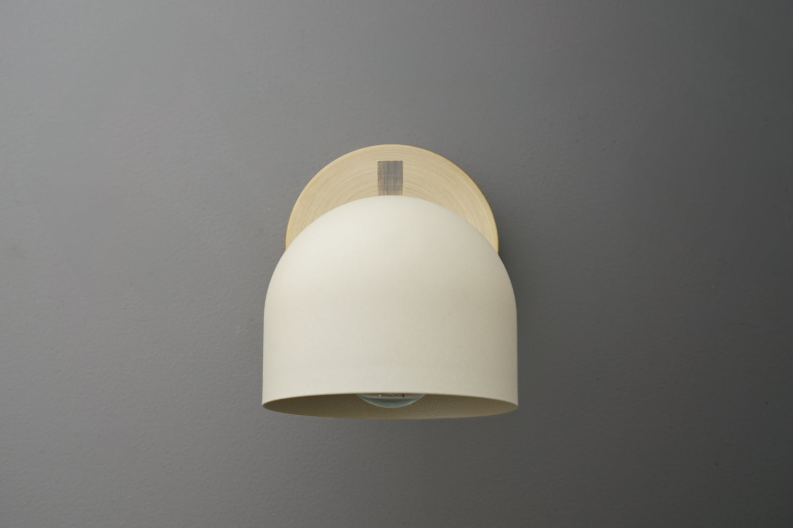 Antique brass wall sconce with smooth cream-colored dome shade and minimalist mounting plate. - SCONCE MODEL NO. 3622