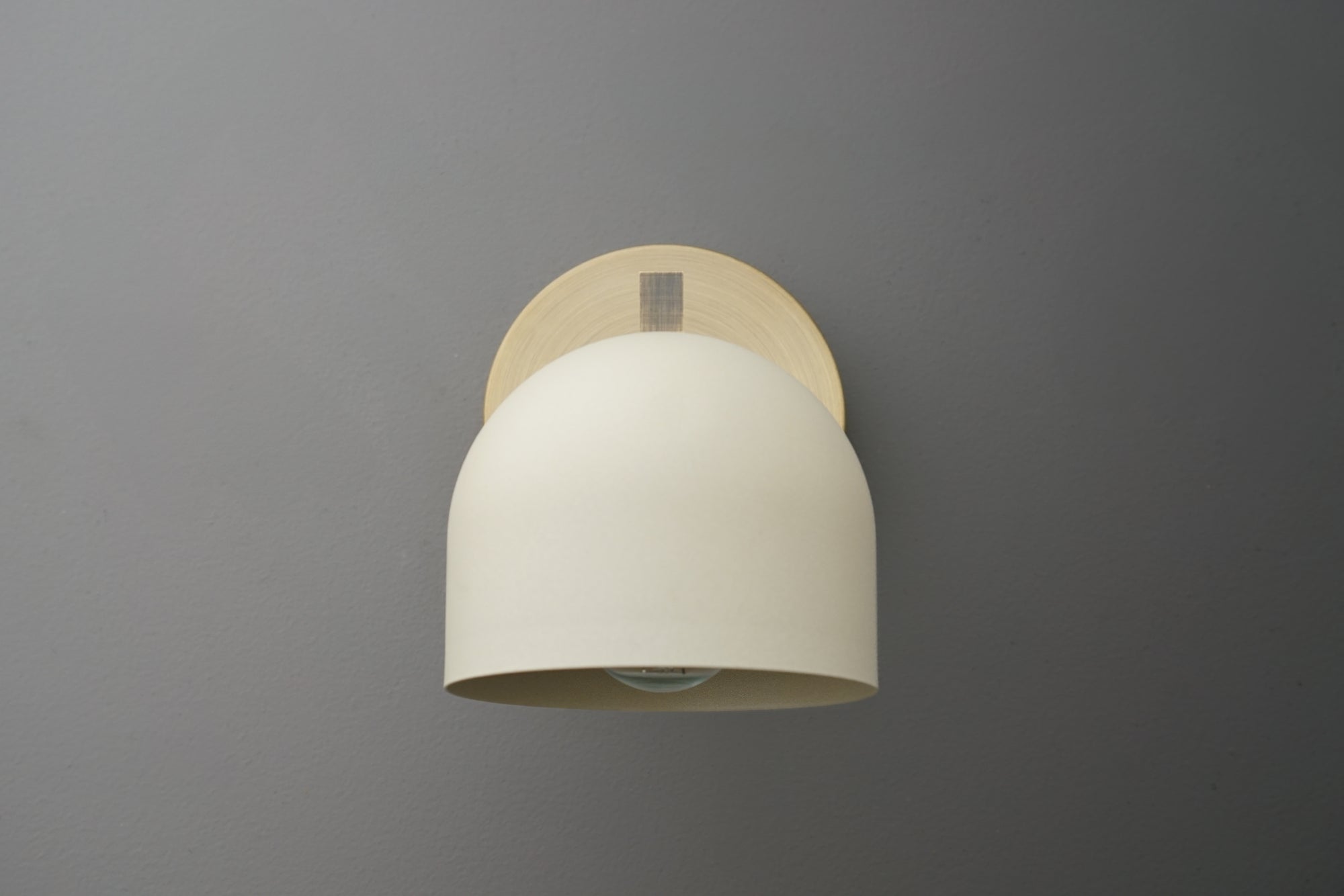 Antique brass wall sconce with smooth cream-colored dome shade and minimalist mounting plate. - SCONCE MODEL NO. 3622