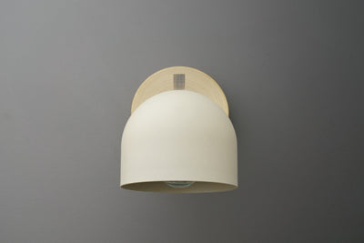 Antique brass wall sconce with smooth cream-colored dome shade and minimalist mounting plate. - SCONCE MODEL NO. 3622