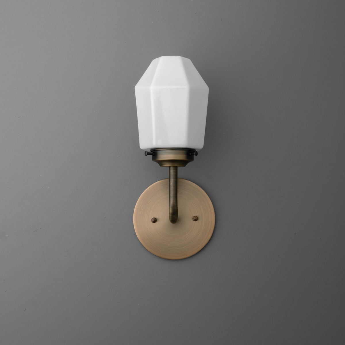 Single-bulb wall sconce with white faceted glass shade and brushed brass round base plate. - SCONCE MODEL NO. 1062