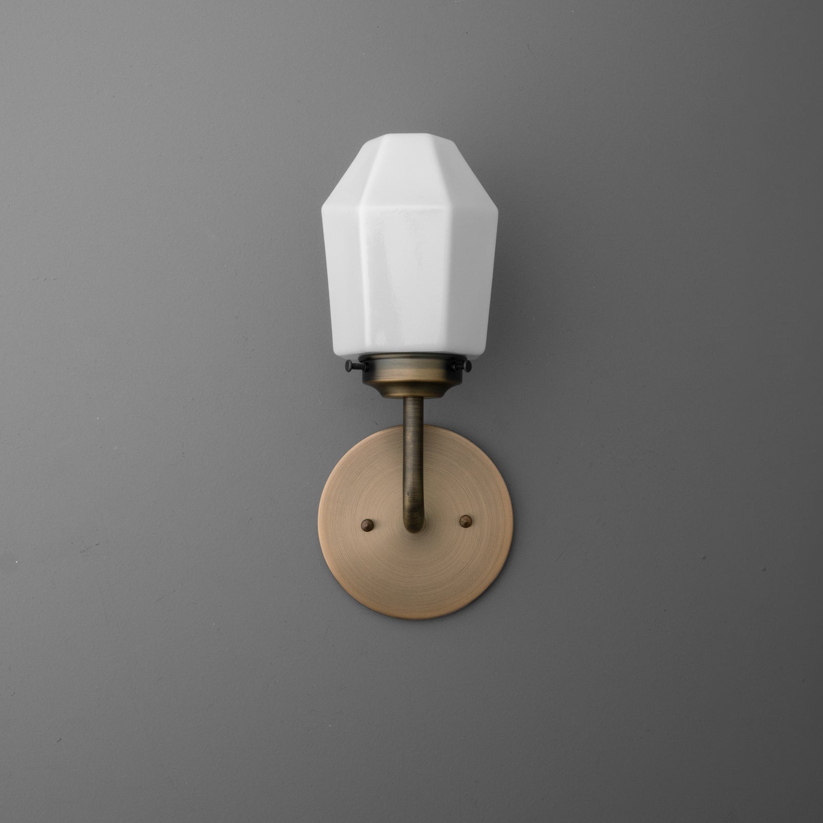 Single-bulb wall sconce with white faceted glass shade and brushed brass round base plate. - SCONCE MODEL NO. 1062