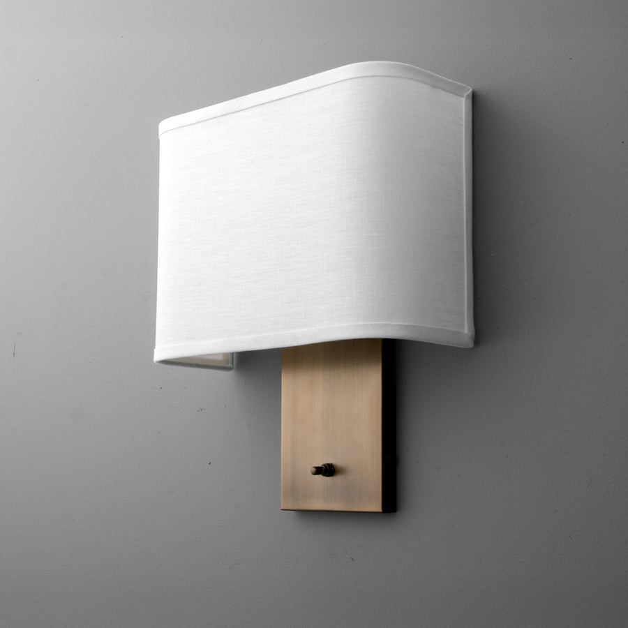 Wall sconce with rectangular white fabric shade and brushed brass backplate with small black switch. - SCONCE MODEL NO. 1918