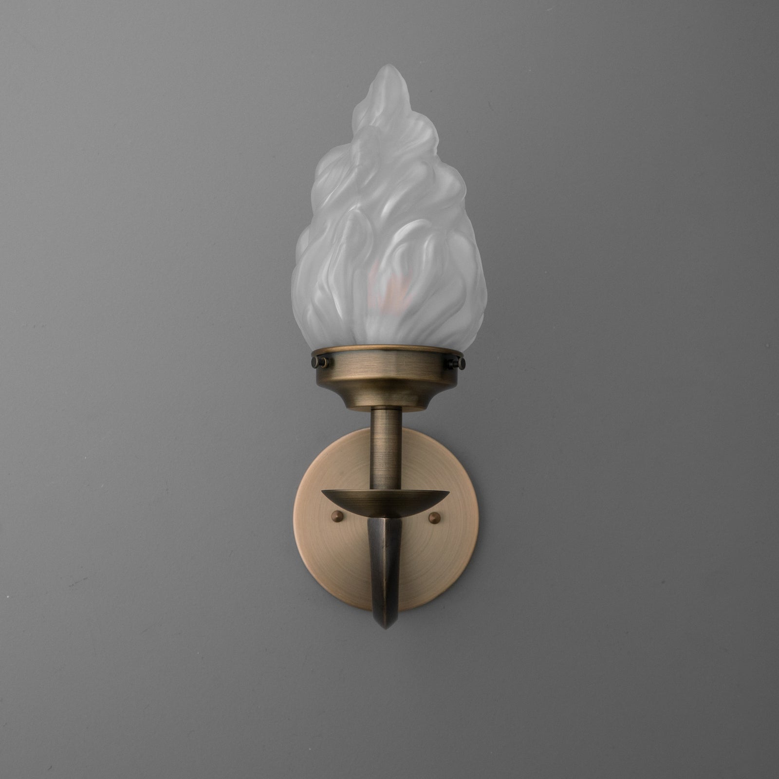 Wall sconce with bronze finish and frosted glass flame-shaped shade, single bulb design. - SCONCE MODEL NO. 1057