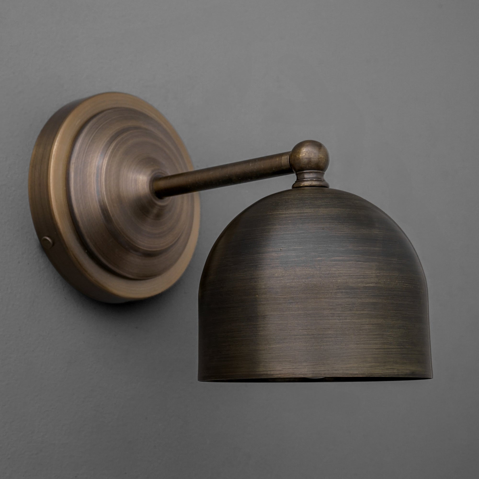 Antique brass wall sconce with rounded shade and classic vintage design on gray background. - SCONCE MODEL NO. 6649